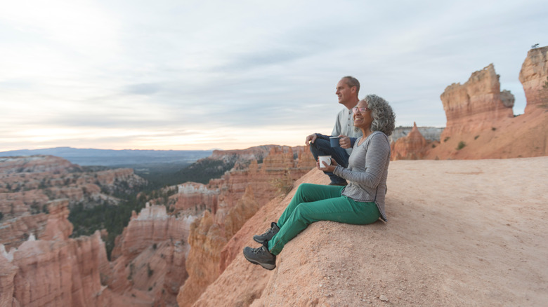 Seniors sitting on a cliff at Bryce Canyon National Park, Utah
