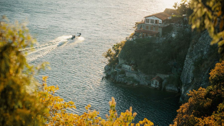 Aerial of La Casa del Mundo with a boat on Lake Atitlán