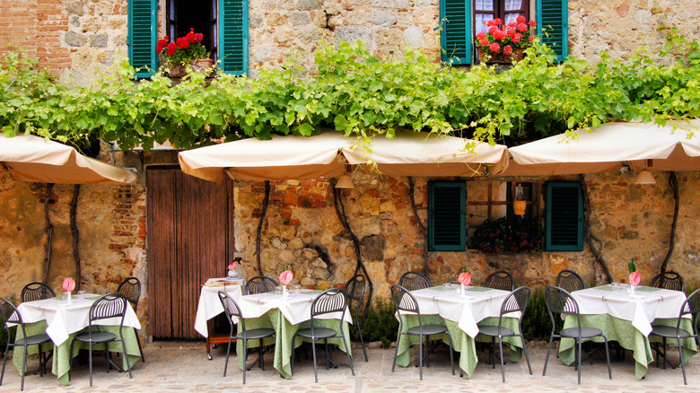Outdoor tables at a fine-dining trattoria in Tuscany, Italy