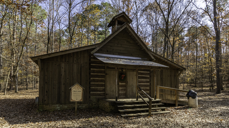Fowler House, a historic cabin rental at Tannehill Ironworks Historical State Park, Alabama, surrounded by trees