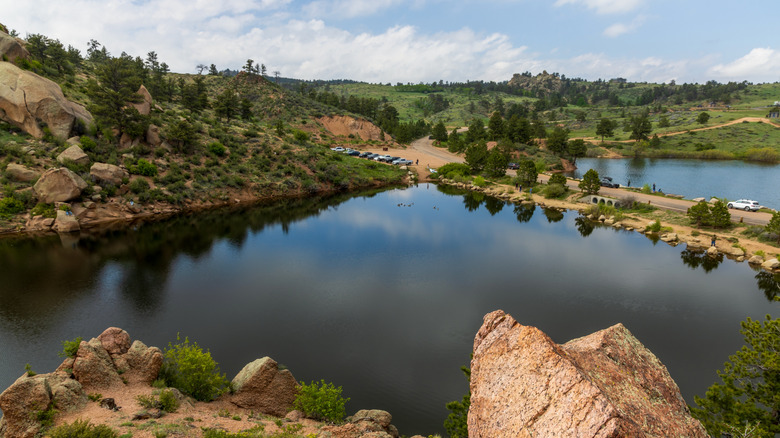 Rocky landscape dotted with greenery surrounding a reservoir at Curt Gowdy State Park, Wyoming