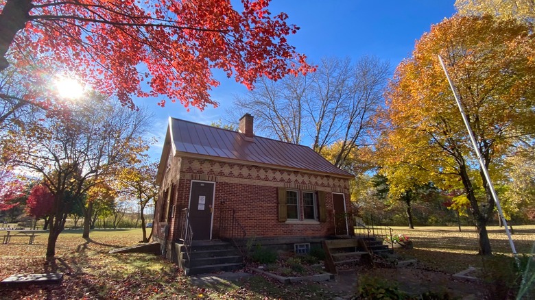The Copper Culture Museum building with red bricks surrounded by trees in the fall at Copper Culture State Park, Wisconsin