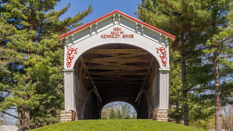 The longwood covered bridge flanked by trees in Connersville, Indiana.
