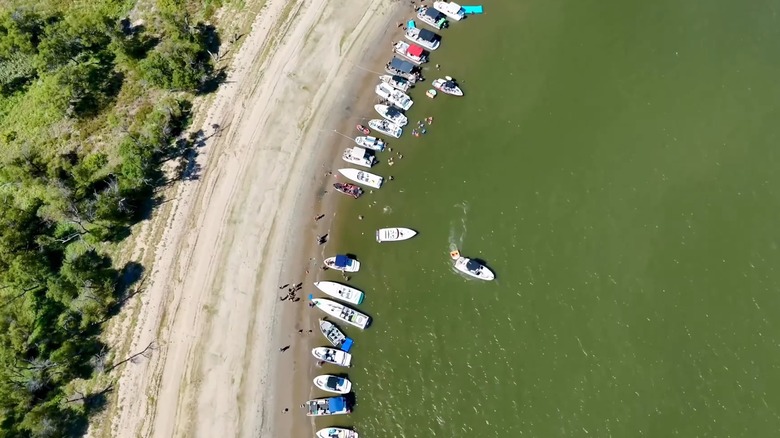 Aerial shot of several boats lining the shore of Kaw Lake