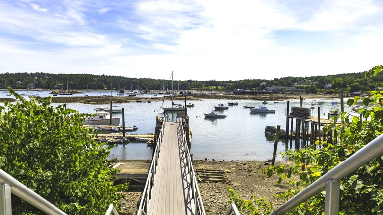 Boats bob beside a pier in Hancock County, Maine