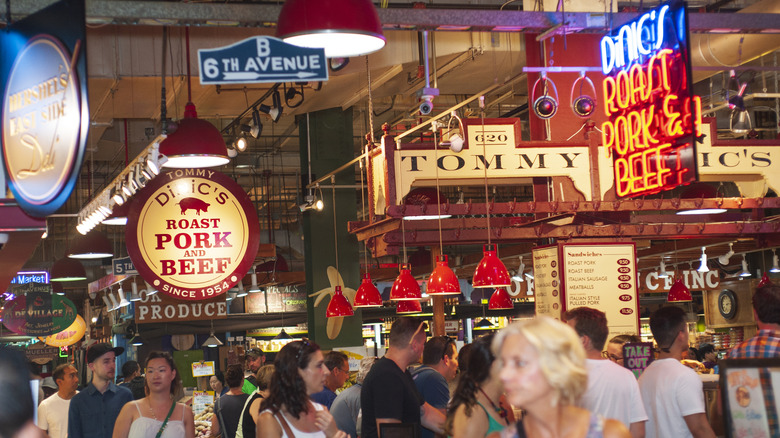 Bright signs are suspended over crowds of patrons in Reading Terminal Market in Philadelphia