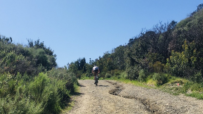 A biker pedals up a dirt stretch of the Fortuna Mountain Trail outside San Diego, California