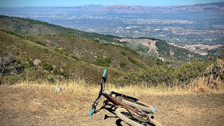 A bicycle lies on a grassy ledge on Mt. Umunhum, California