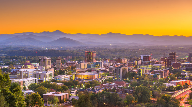 Aerial view of downtown Asheville and mountains at sunset
