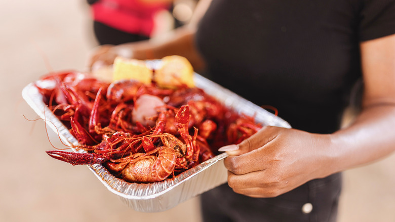 A server carries a platter of fresh seafood