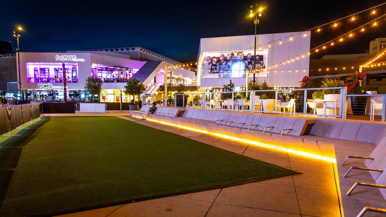 Downtown Commons (DOCO)'s outdoor area glowing with string lights at night in Sacramento.