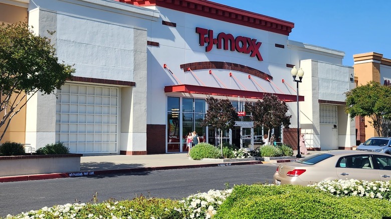 The white and red facade of TJ Maxx with flowers and trees planted in the parking lot at Sacramento gateway mall.
