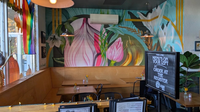 Floral and onion mural on the wall inside The Bloomin' Onion, a vegan restaurant in Asheville, North Carolina