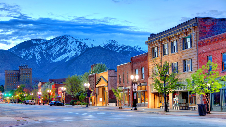 A street in Ogden at sunset with mountains in the background