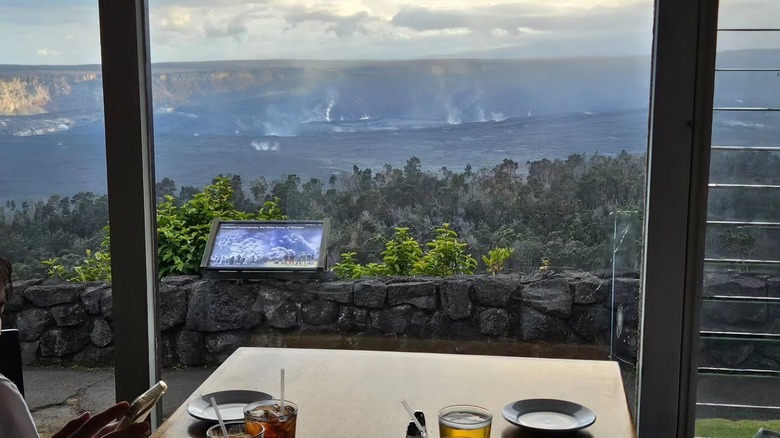 View from a dining table at The Rim at Volcano House, Hawaii, overlooking a steaming crater