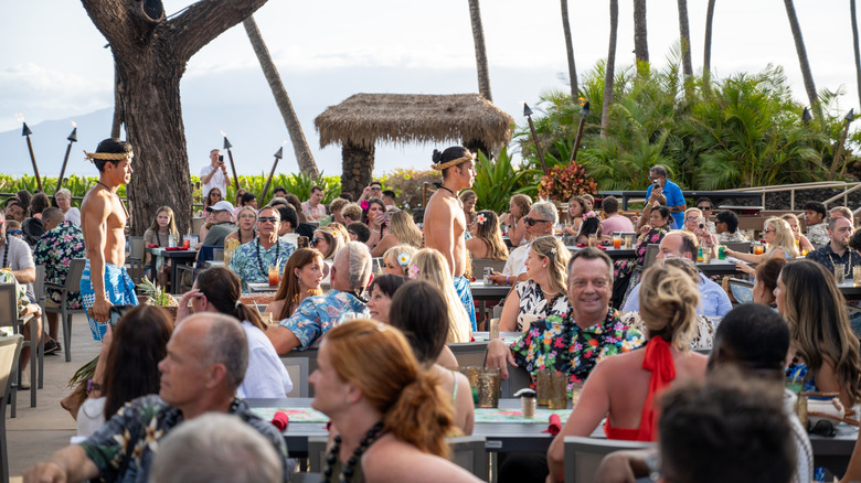 Performers conduct an imu ceremony in front of seated guests at the Drums of the Pacific luau in July 2026