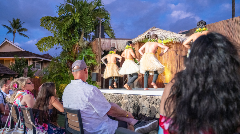 Tourists watching a hula dancing show in Hawaii