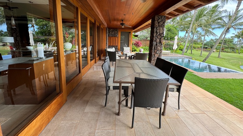 A porch overlooking a pool at the Lodge at Kukui'ula in Kauai