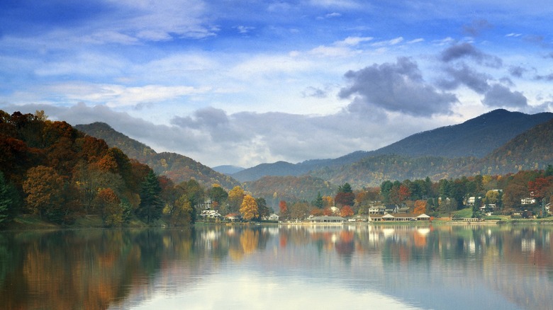 Fall foliage on forested hills and mountains surrounding Lake Junaluska in North Carolina's Haywood County