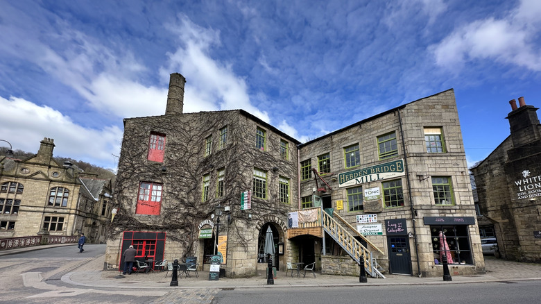 Hebden Bridge's eponymous mill, which is now an independent shopping hub, beneath a blue sky