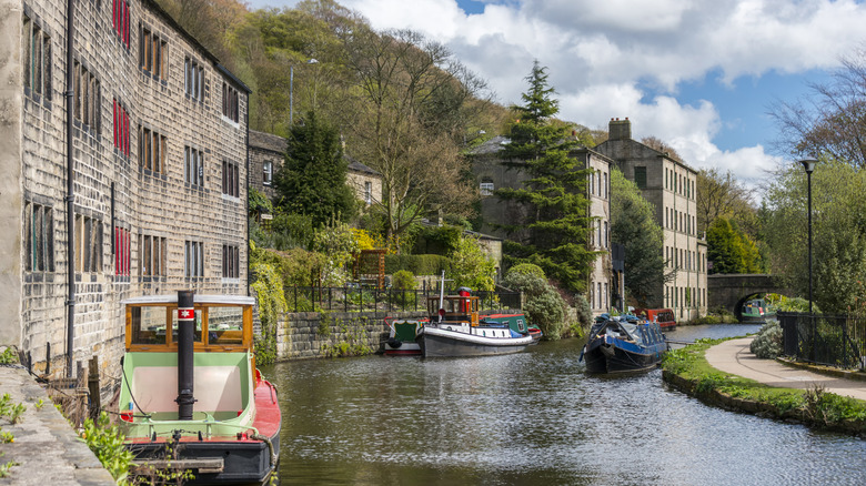A path, trees, and Victorian buildings line the Rochdale Canal in Hebden Bridge