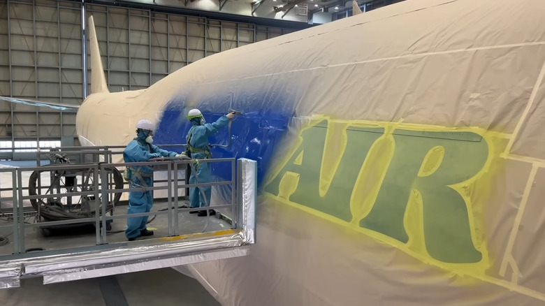 Workers paint Korean Air aircraft
