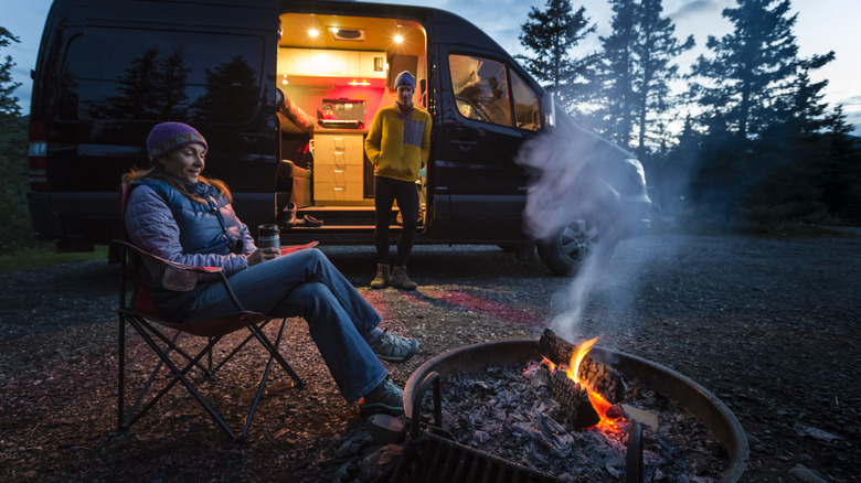 campers near van and campfire
