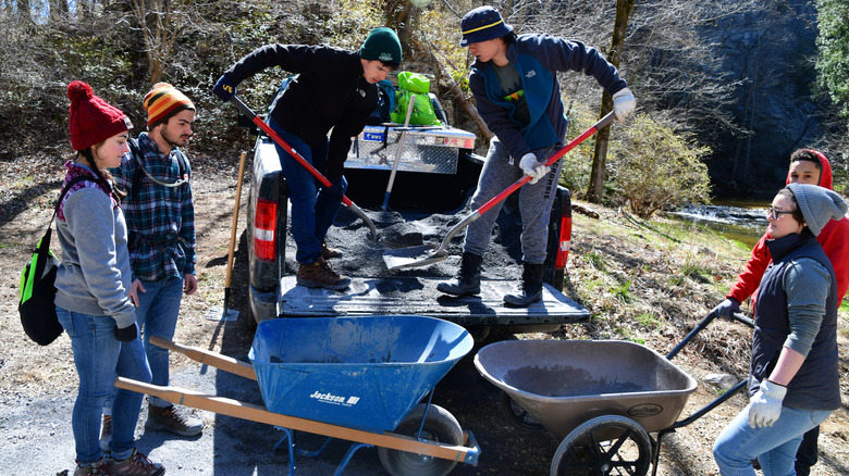 Volunteers in nature with shovels and wheelbarrow