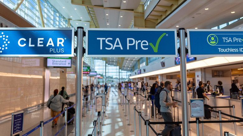 TSA Pre signs and people lining up at the airport