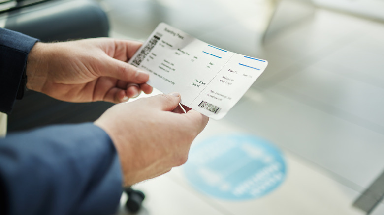person holding boarding pass