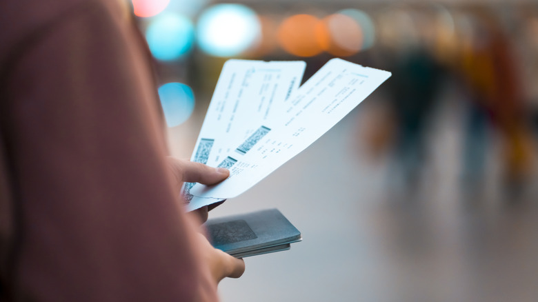 Person holding flight tickets