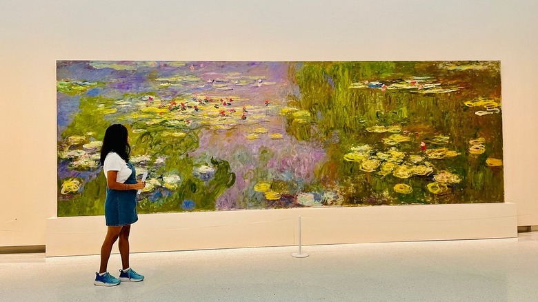 A visitor looking at Water Lilies (Nymphéas) by Claude Monet at the Carnegie Museum of Art in Pittsburgh