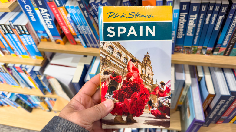 A close-up of Rick Steves' guidebook to Spain in a bookstore