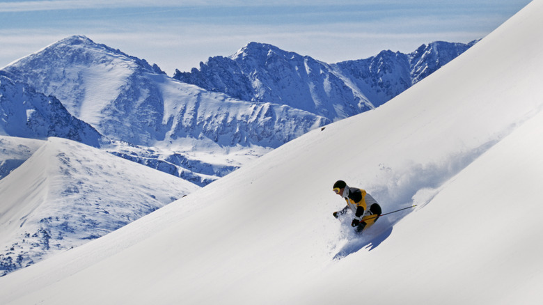 Man skiing down powdery mountain