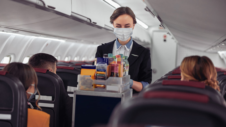 flight attendant with drinks cart