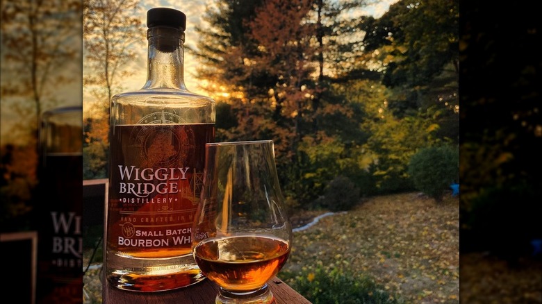 Wiggly Bridge Distillery bottle and glass at sunset
