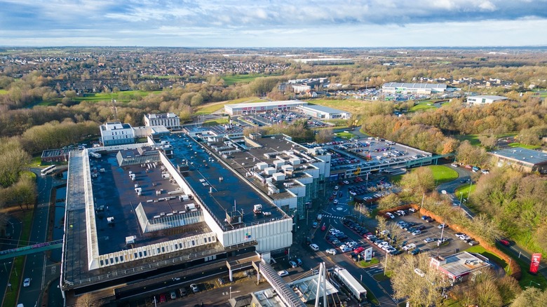 The roof and parking lot of Skelmersdale's Concourse Shopping Center surrounded by trees in winter