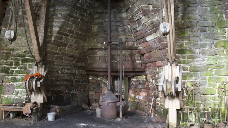 A historic cast iron steel works at Hopewell Furnace with pulleys and brick walls