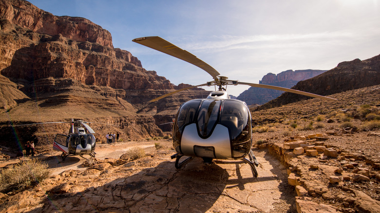 Helicopter tour over Grand Canyon and tourists exploring it.