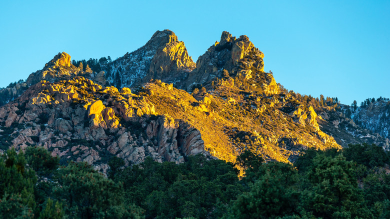 Snow-dusted mountain peaks in sunlight in Hualapai Mountain Park, Arizona