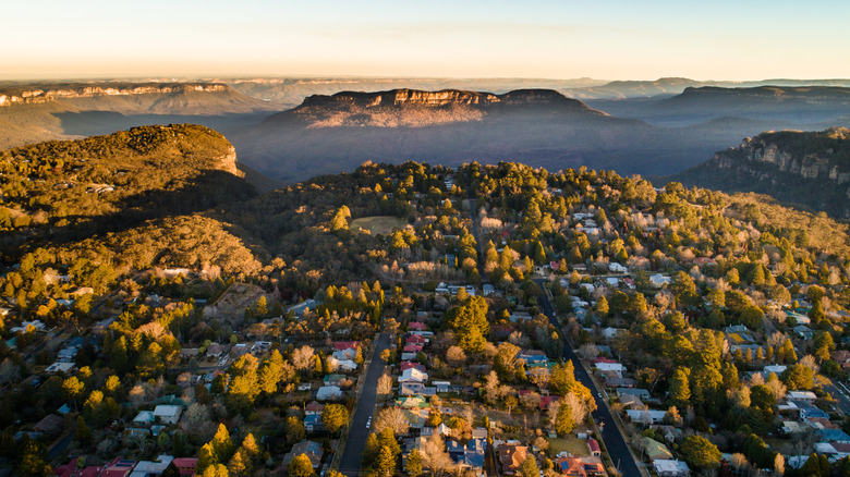 An aerial view of a mountain town at sunset