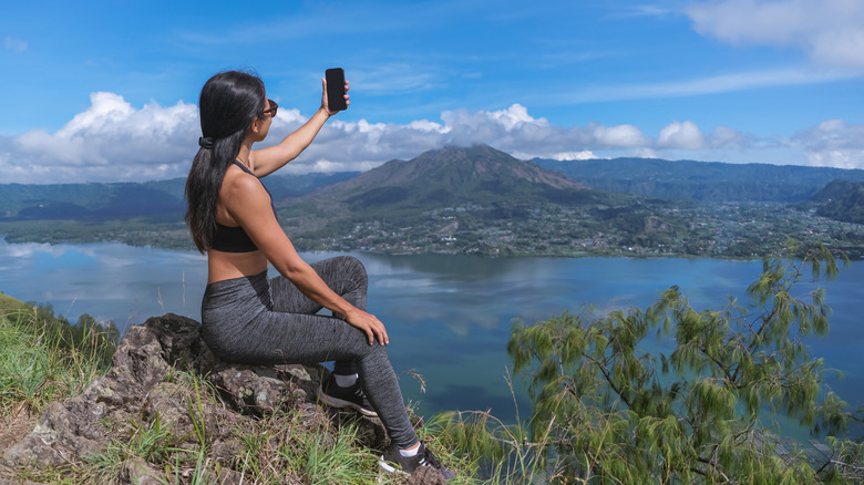 Woman taking selife on hill in Bali