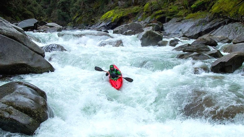 Kayaker paddling down rapids at Slab Creek Reservoir