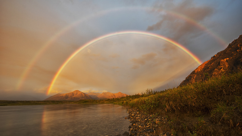 Double rainbow at sunset on river