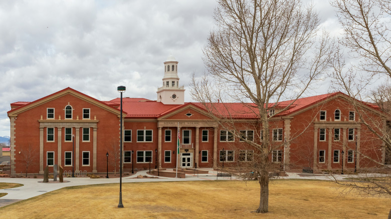 Exterior of a college in Alamosa with a red roof and orange brick
