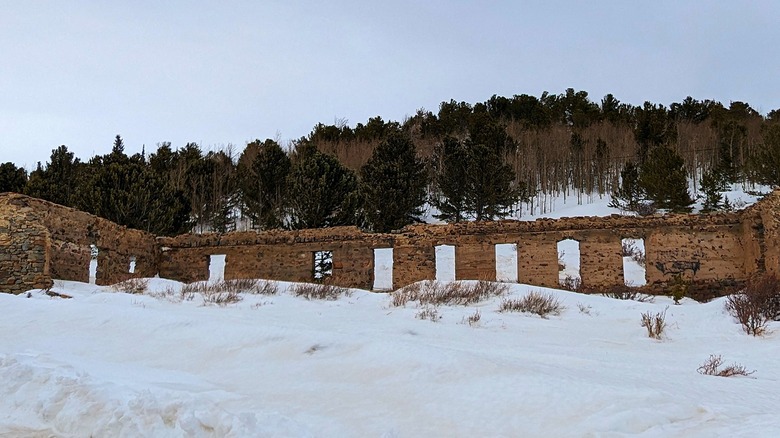 Close-up view of abandoned structure and snowy surroundings in Caribou, Colorado