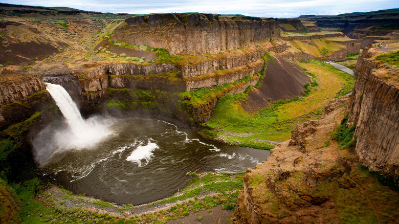A waterfall crashes into a pool in a gorge