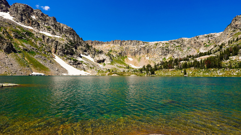 Mountains rise abov ethe azure waters of Lake Solitude