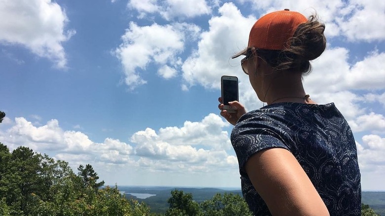 person holding phone taking picture