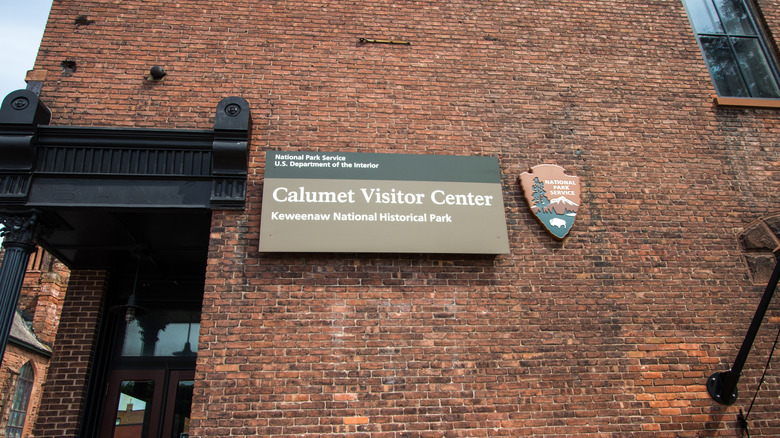 Side of brick building with Calumet Visitor Center National Park Service sign